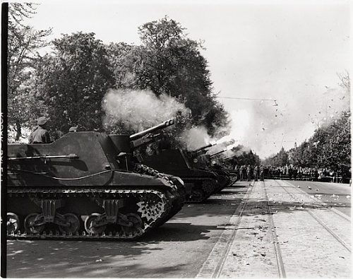 Sexton SP guns of the 8th Field Regiment, R.C.A., firing 21 gun salute to celebrate VE Day, Gron.jpg