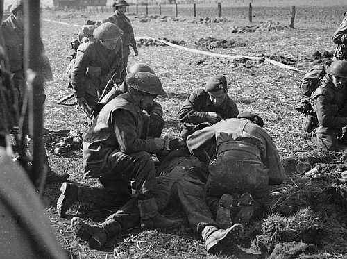 Regimental Aid Party treating a infantryman of The South Saskatchewan Regiment who was wounded b.jpg