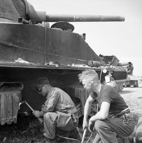 REME_personnel_cutting_suspension_components_from_a_Sherman_tank_at_a_vehicle_salvage_dump_in_No.jpg